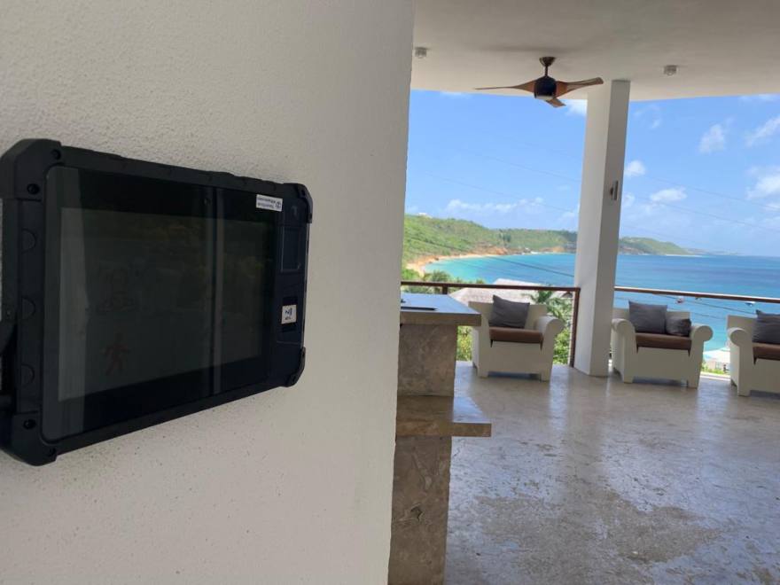 PunchClock clock on a white wall of a villa terrace overlooking the sea